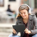 Girl learning on line with a tablet and headphones