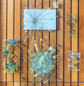 Part of the art piece at Campbell Library displaying four glass panels.
